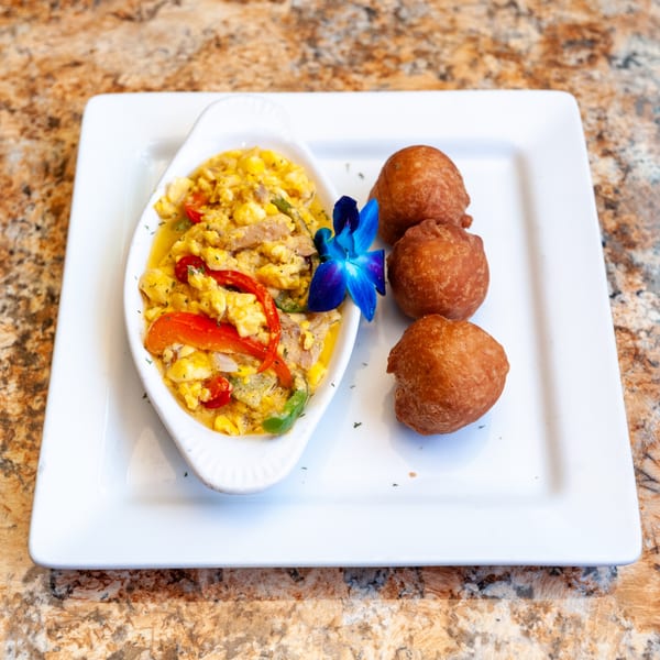 Dunns River Island Cafe's Jamaican ackee and saltfish with fried dumplings and a blue orchid.